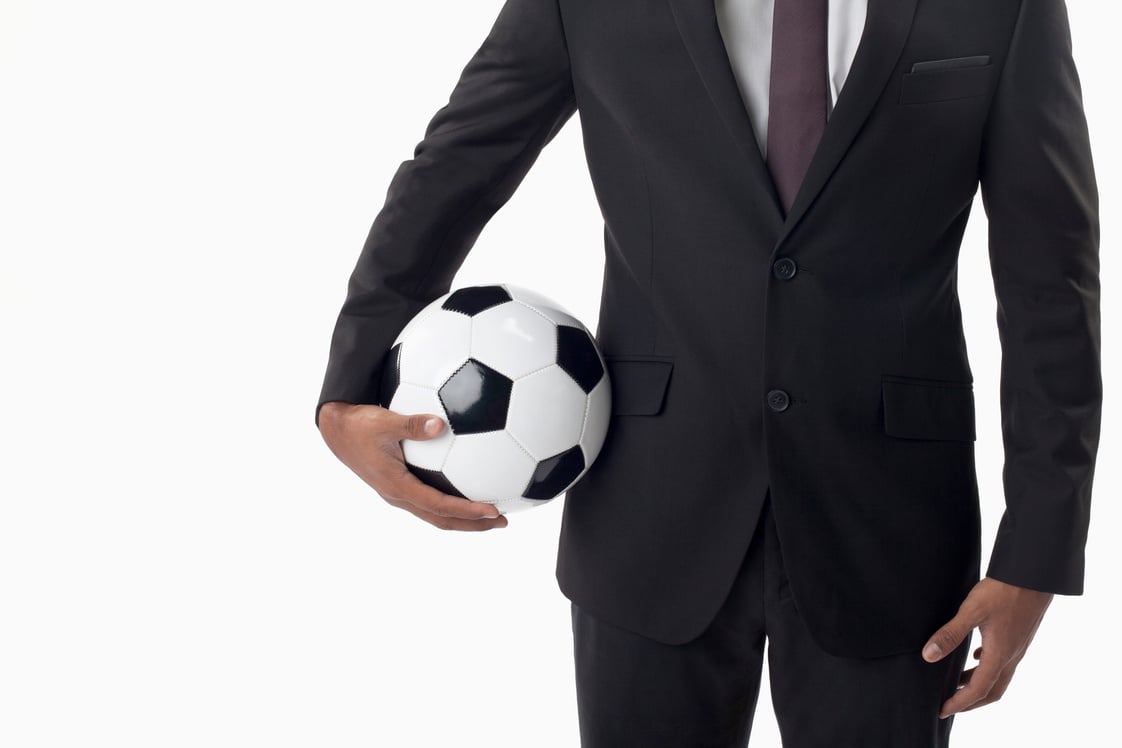 Soccer manager holding a ball